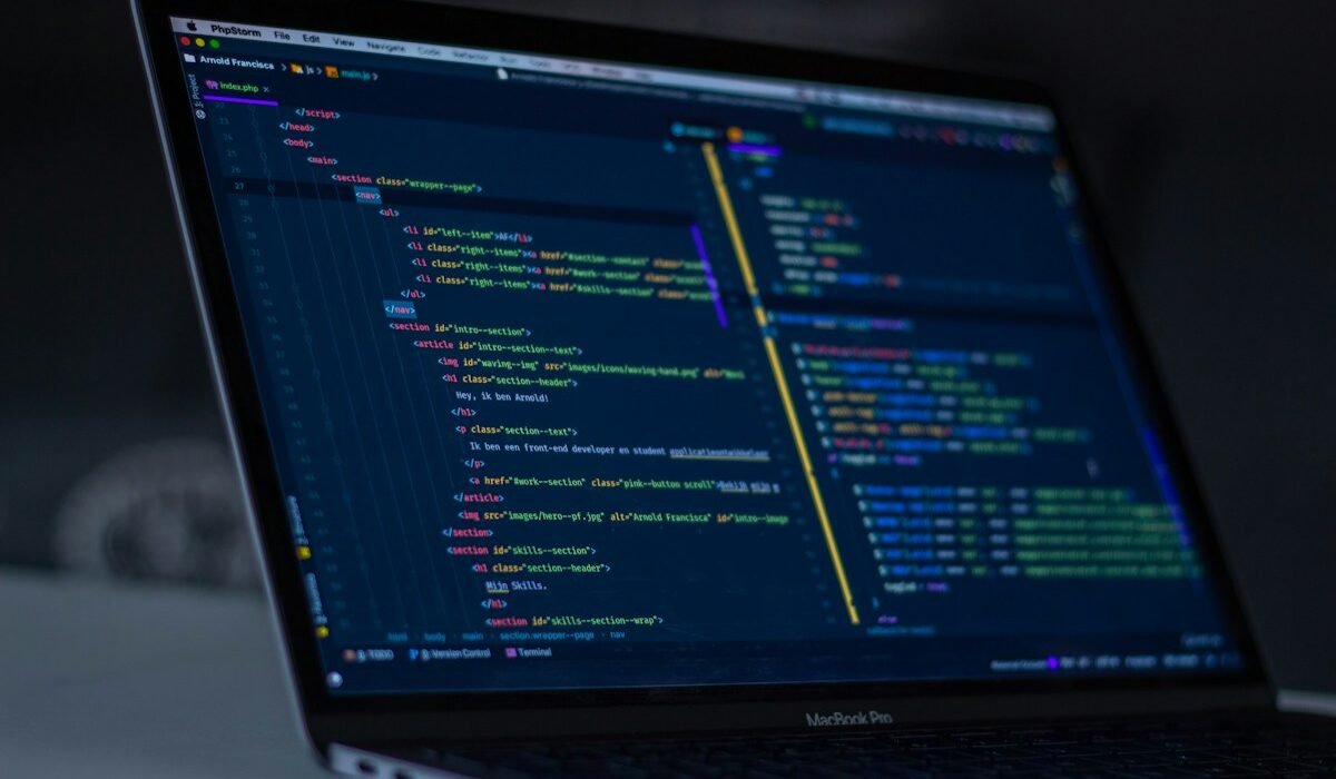 Laptop displaying code in a software development workspace